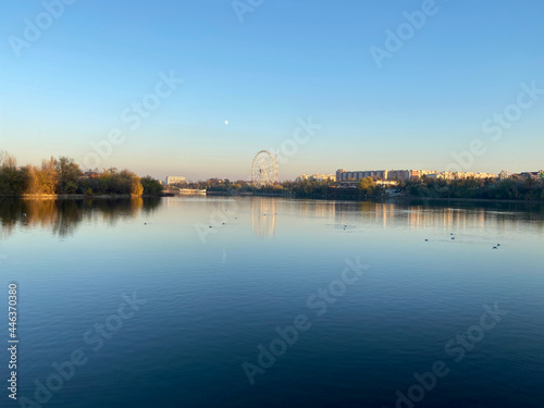 Lake with city reflection on sunset landscape view of