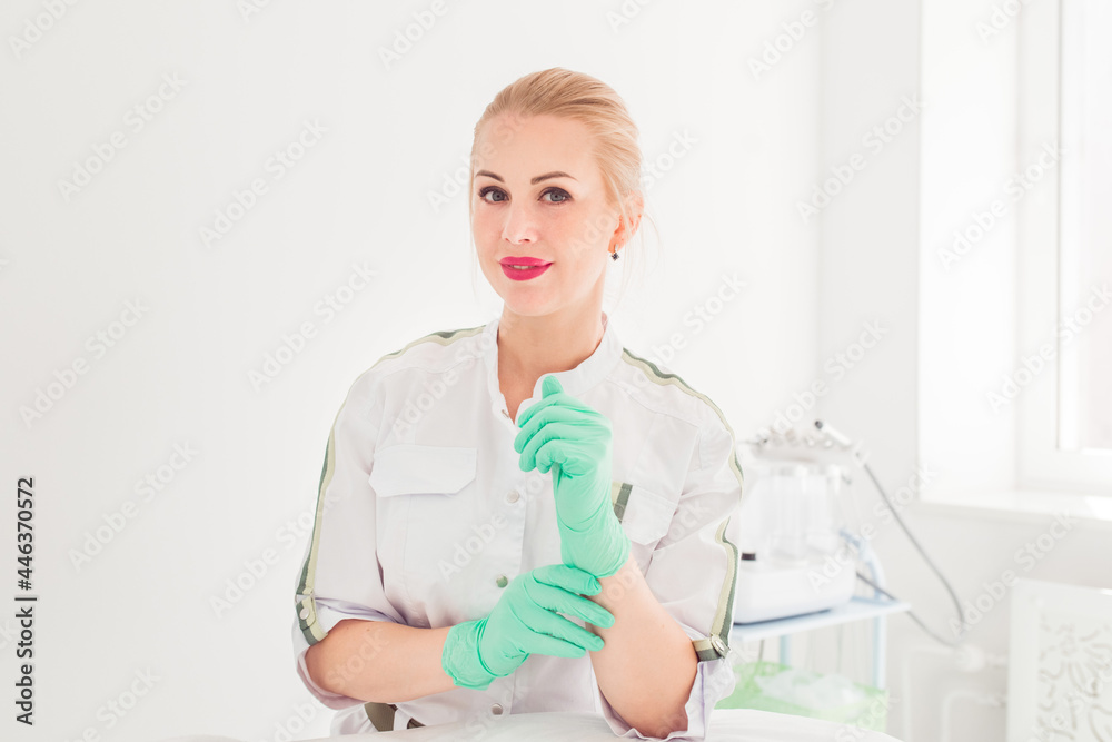 young professional beautician on the background of a beauty salon, beautiful woman cosmetologist in medical clothes in cosmetology office young professional beautician on the background of a beauty salon, beautiful woman cosmetologist in medical clothes in cosmetology office