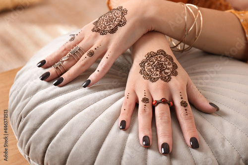 Woman with henna tattoos on hands, closeup. Traditional mehndi ornament photo