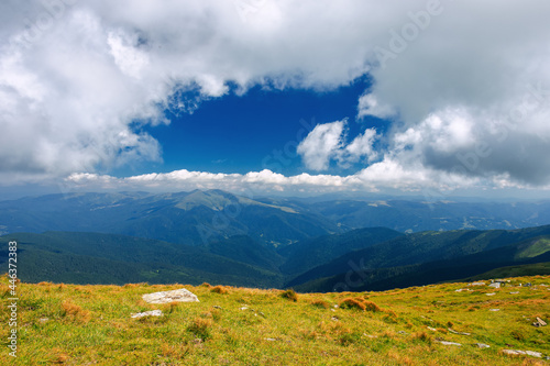 mountain landscape on a sunny day. beautiful nature background. gorgeous cloudscape above the mountain ridge with grassy meadows. travel back country concept © Pellinni