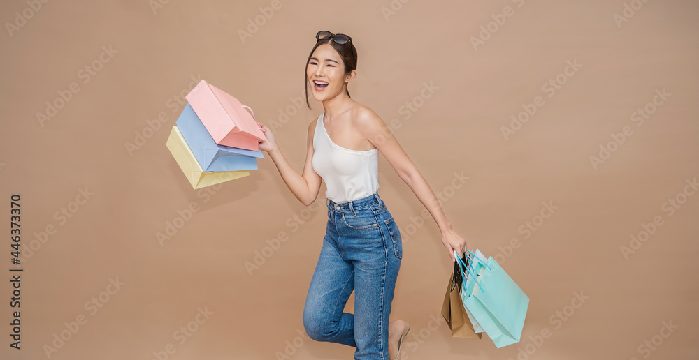 Portrait of happy beautiful shopaholic asian woman carry shopping bags, summer fashion sale model Asia girl with copy space, outlet department store advertising concept isolated banner background - obrazy, fototapety, plakaty 