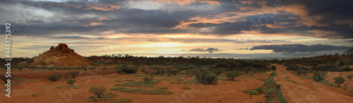 Landscape showing earthy coloured boulders against a dramatic sky in the Australian outback