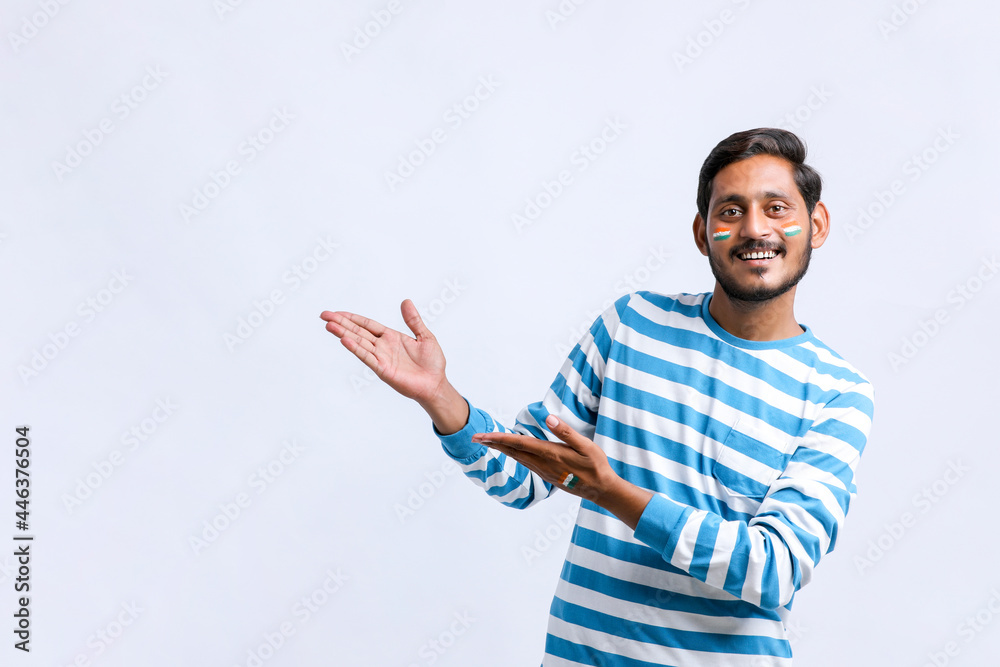 Young indian man giving shocking expression and showing direction with hand Young indian man giving shocking expression and showing direction with hand