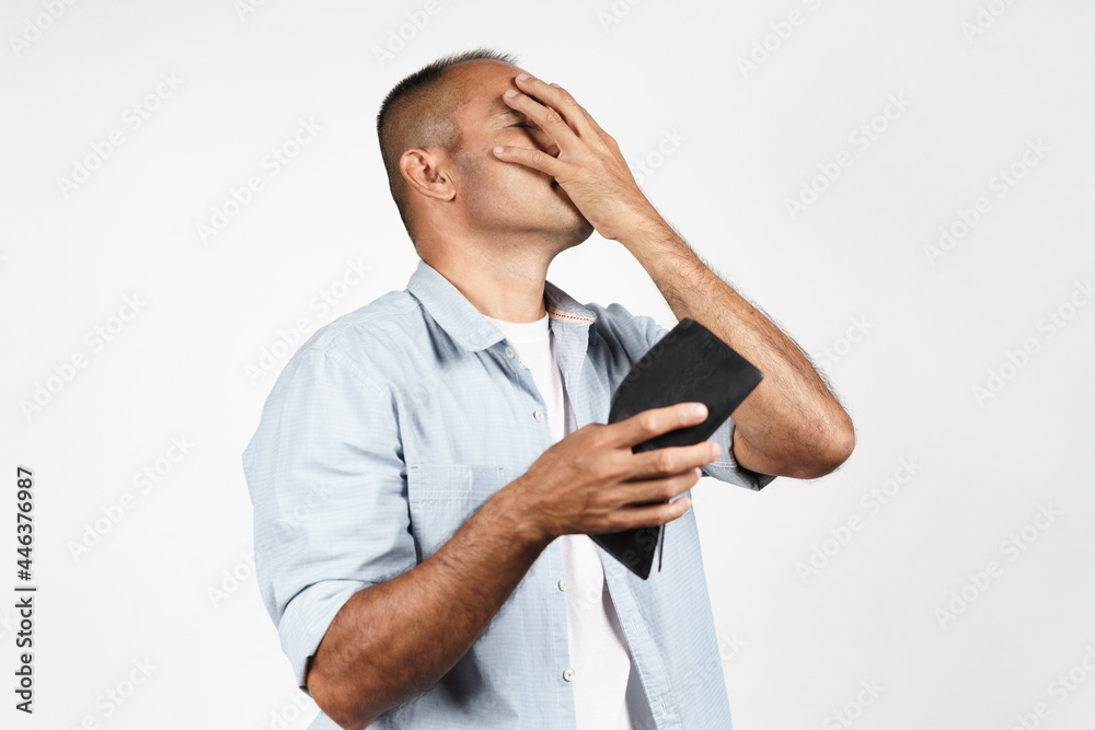 Upset mature man holding his empty wallet on white background. financial crisis, bankruptcy, no money, bad economy Concept.. Upset mature man holding his empty wallet on white background. financial crisis, bankruptcy, no money, bad economy Concept..