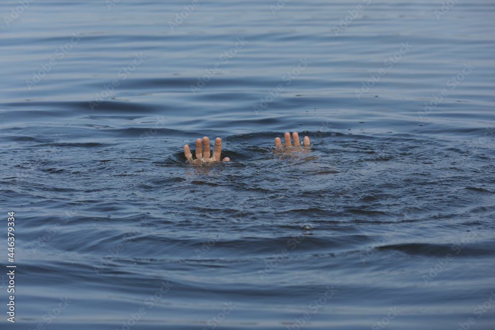Drowning man reaching for help in sea, closeup Drowning man reaching for help in sea, closeup