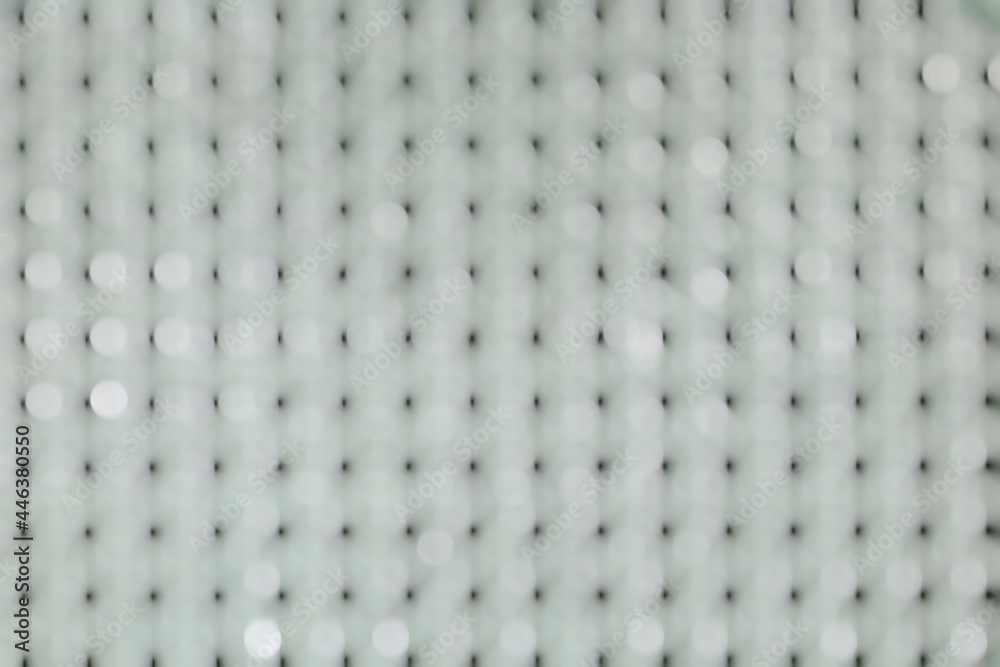 Abstract white bokeh on a white background with rows of black dots. Abstract white bokeh on a white background with rows of black dots.