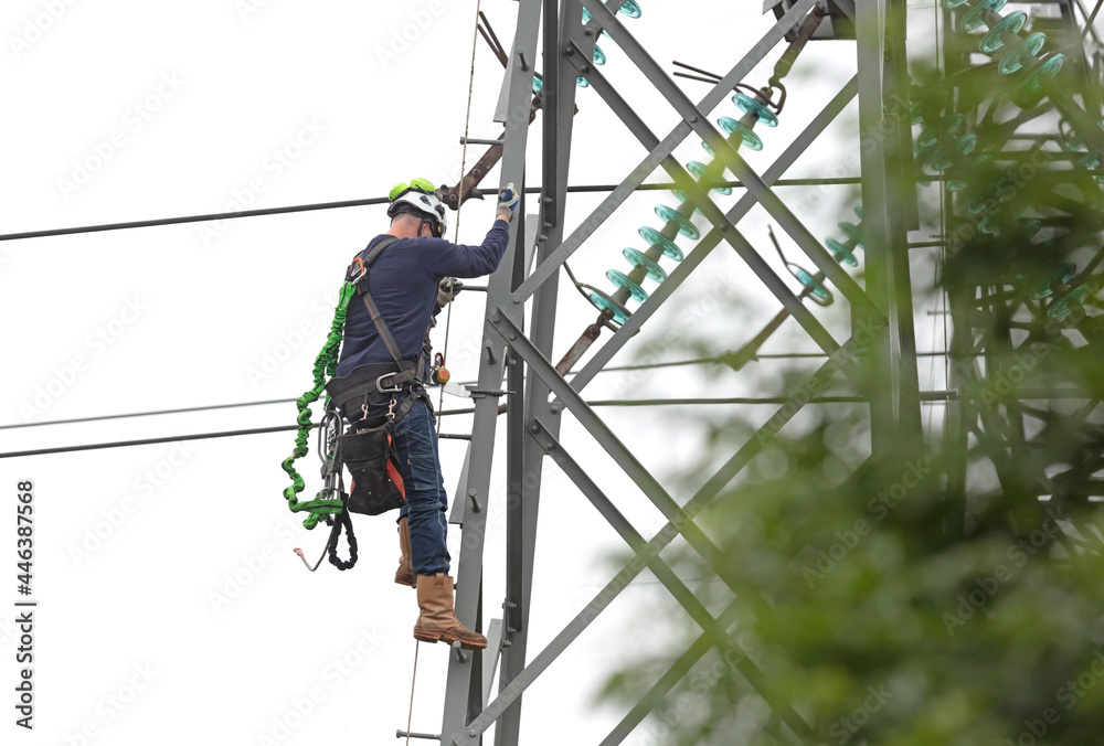 Electrician is working on a pole