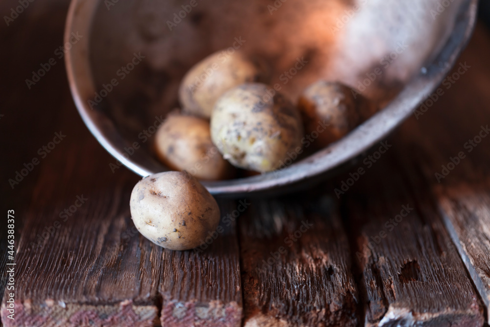 Fototapeta premium Fresh vegetables close-up on a wooden table. Onions, potatoes, garlic