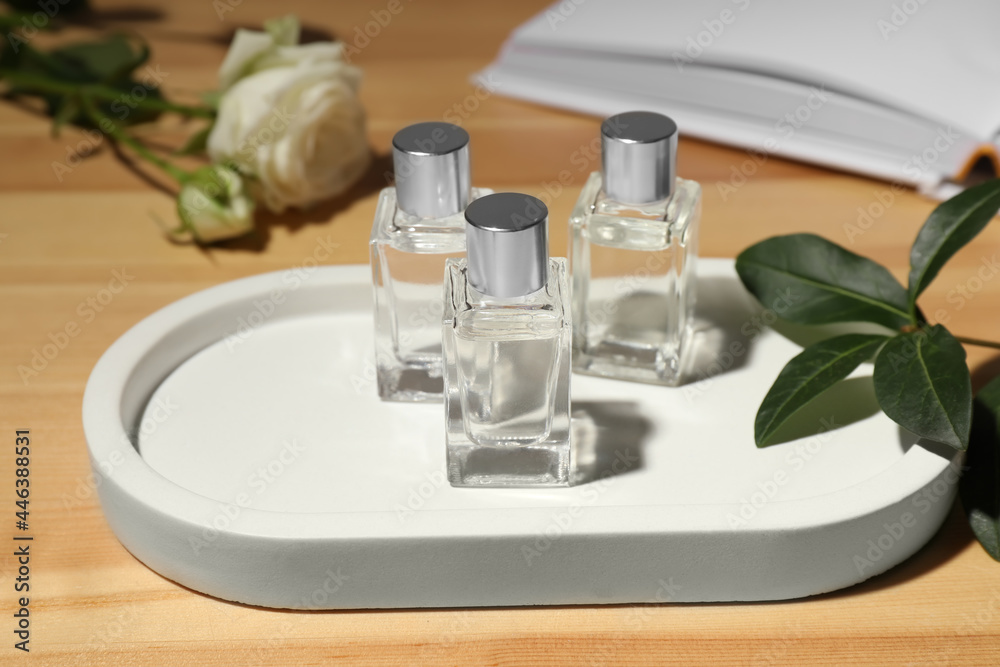 Bottles of essential oil on wooden table Bottles of essential oil on wooden table