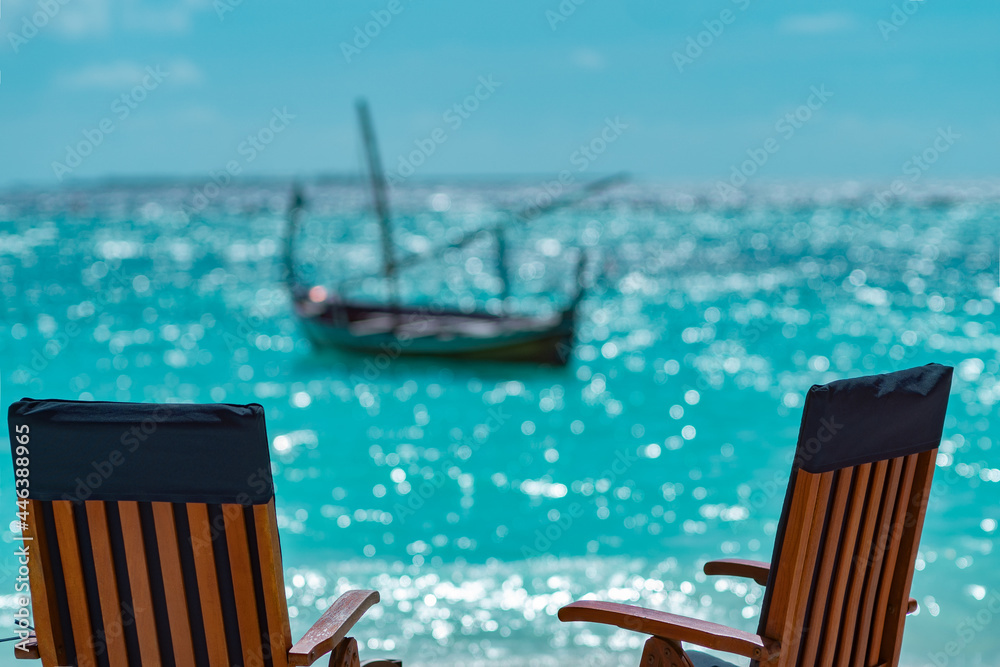 Fototapeta premium Two chairs on the background of indian ocean