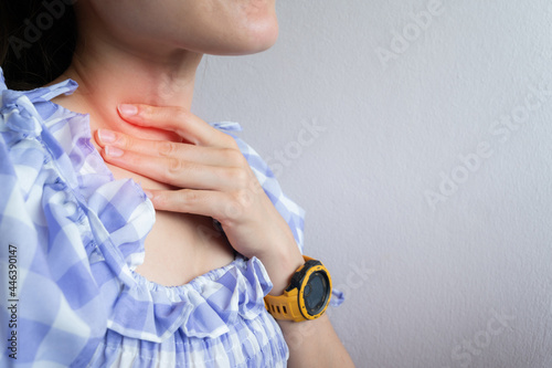 Close up of woman coughing while she having sore throat problem. A sore throat is a painful, dry, or scratchy feeling in the throat.