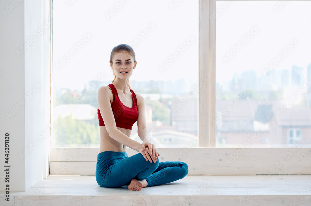 woman sitting near the window yoga meditation relaxation