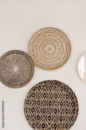 Traditional oriental ornamental ceramic plates on white wall. Beautiful decoration background