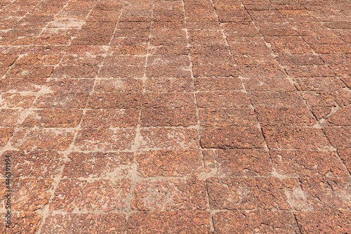 Brown laterite stone floor outside the building at the ancient site photo