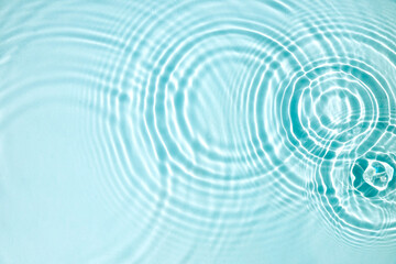 Blue water texture, blue mint water surface with rings and ripples. Spa concept background. Flat lay, copy space.