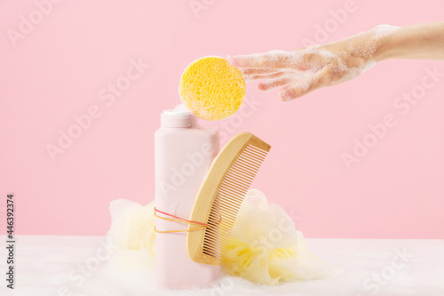 Bottle of bath gel with a comb and a sponge photo