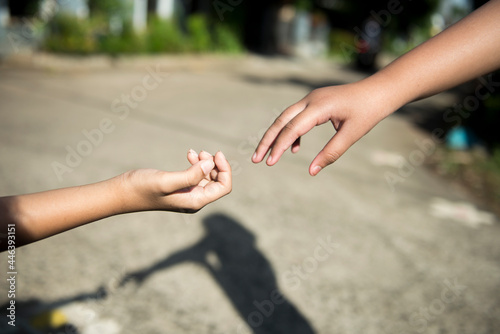 Human hand giving helping hand © Leo Lintang