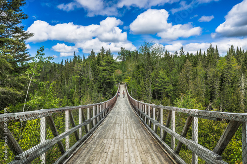 View from the Rimouski river on the highest suspended footbridge in Quebec, 63 meters high and 99 meters long, located in Canyon des Portes de l'Enfer (Hell's gate Canyon) in Quebec, Canada