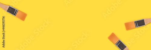 Banner with paint brushes on a yellow background. Artistic creative concept.