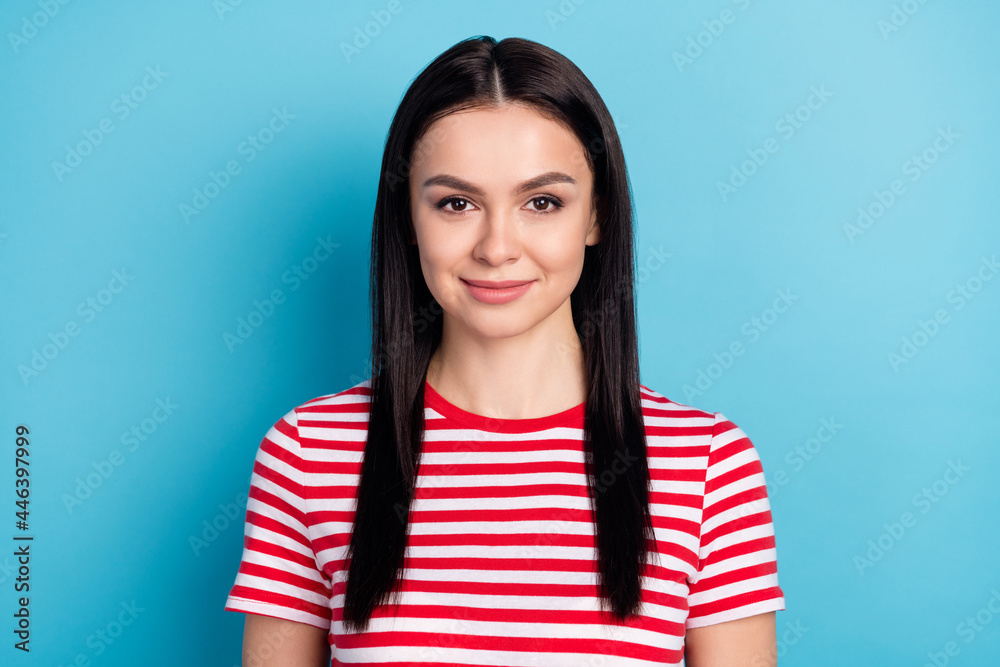 Photo of young beautiful smiling cheerful young woman wear red striped t-shirt isolated on blue color background Photo of young beautiful smiling cheerful young woman wear red striped t-shirt isolated on blue color background