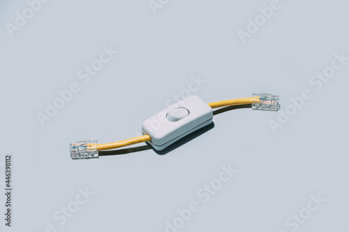 Network cable with switch button isolated on grey background photo