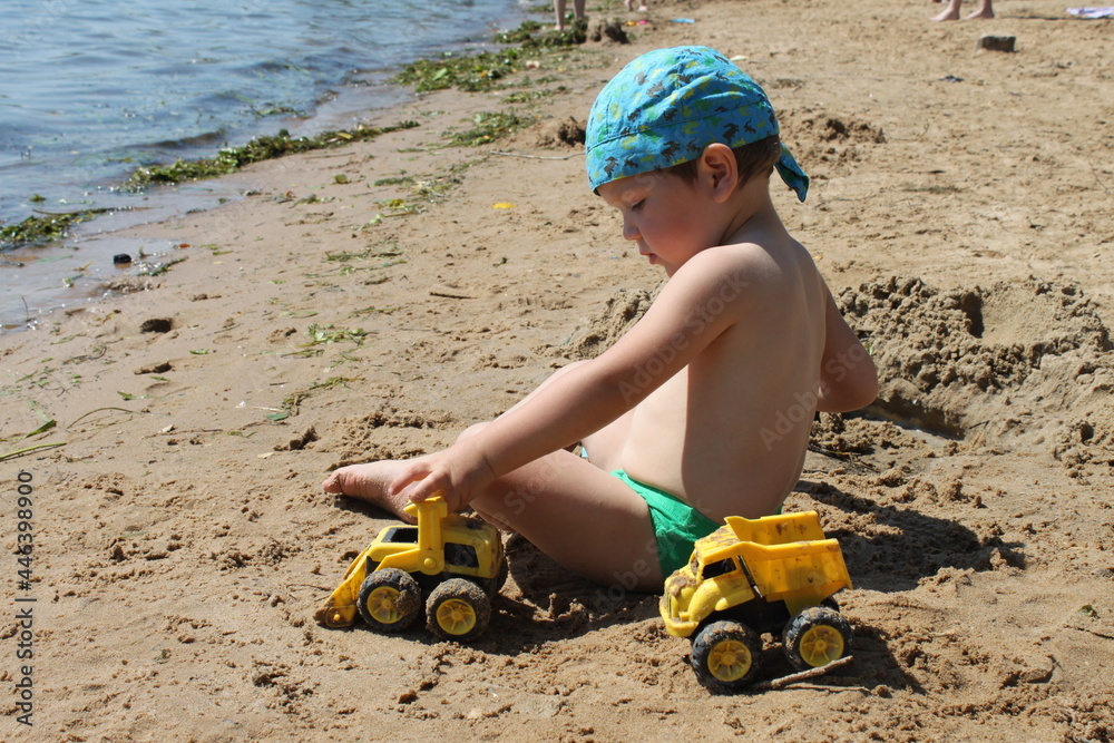 child boy playing on the beach in the sunshine child boy playing on the beach in the sunshine