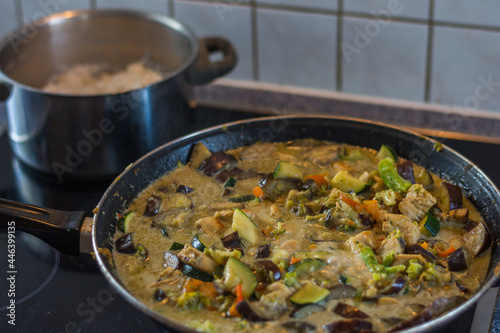 fresh healthy thai green curry and chicken and yasmine rice in a pot photo