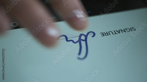 Finger puts an electronic signature on the tablet screen.