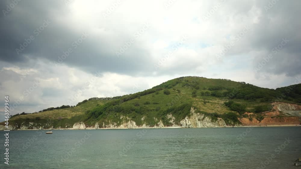 Seascape with a transparent sea and a stone shore Seascape with a transparent sea and a stone shore