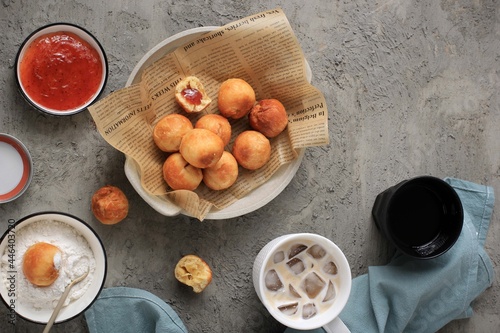 Bandung, Indonesia, 09262020: Indonesian Fried Bread Called Roti/Kue Bantal/Mini Bomboloni with Strawberry Jam or Famous Name Odading, Selected Focus. photo