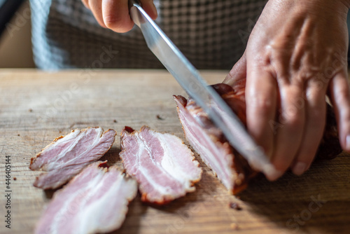 fresh, Polish, smoked bacon, sliced on a kitchen board