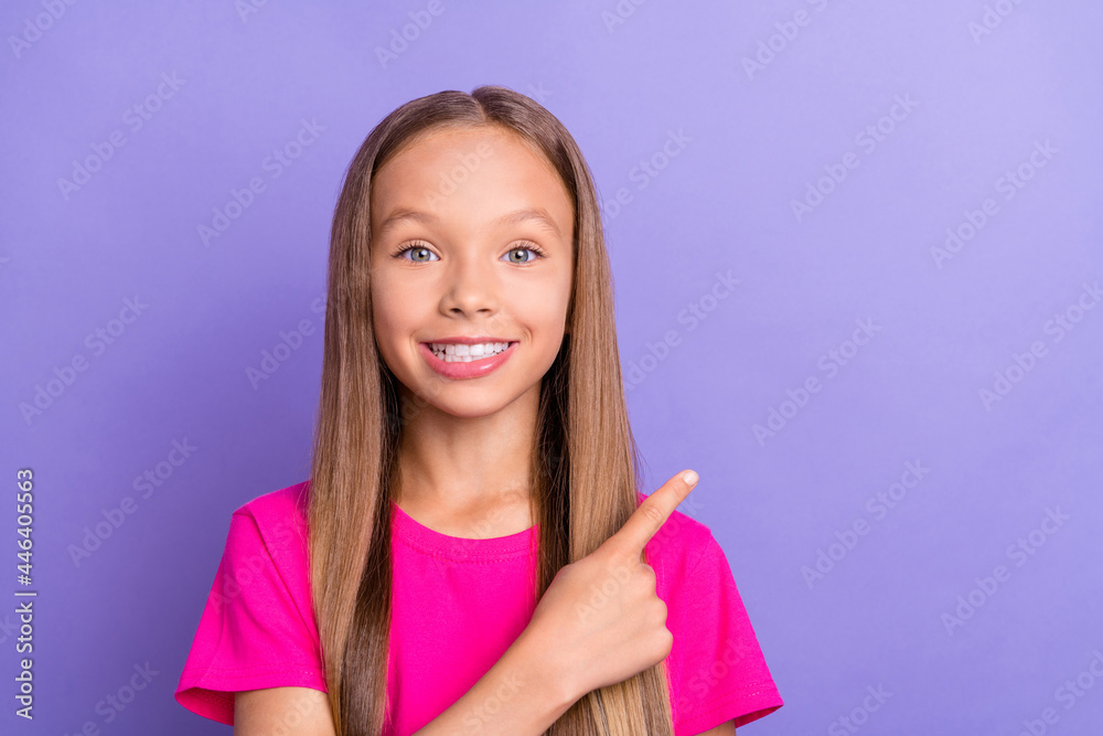 Photo of young cheerful happy positive girl point finger empty space sale news isolated on purple color background Photo of young cheerful happy positive girl point finger empty space sale news isolated on purple color background