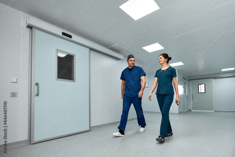 Doctors surgeons walk along the corridor of the clinic in suspense, preparing for a complex operation.
