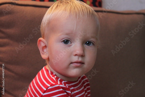 portrait of a cute child boy in red indoors