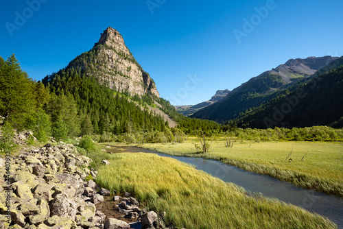 Lac des Sagnes in Summer with La Tour des Sagnes pyramidal shaped mountain. Ubaye Valley in the Mercantour National Park. Jausiers, Alpes de Haute Provence in the French Alps, France