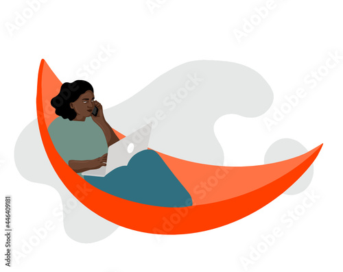 Woman on a hammock being on the phone with a laptop in their lab. Grey blurry background. 