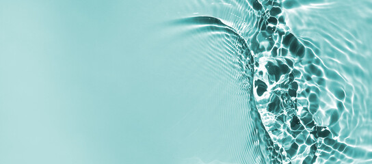 Trendy summer nature banner. 
Defocused aqua-mint liquid colored clear water surface texture with splashes bubbles with copy space. Water waves in sunlight background. 