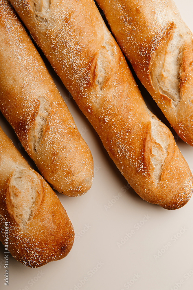 Fresh homebaked delicious baguettes on a white background