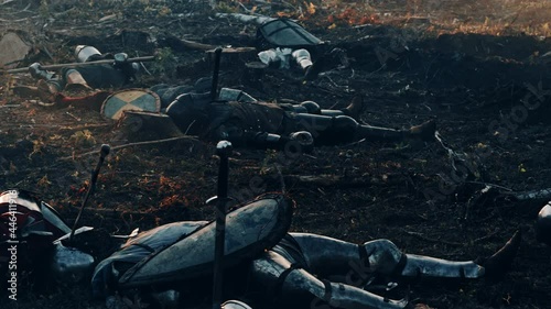After Epic Battle Bodies of Dead, Massacred Medieval Knights Lying on Battlefield. Warrior Soldiers Fallen in Conflict, War, Conquest, Warfare, Colonization. Cinematic Dramatic Historical Reenactment photo