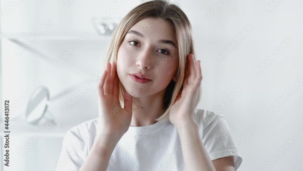 Clean face model. Morning freshness. Healthy beauty. Relaxed confident girl with nude makeup radiant flawless skin posing in light blur room interior. Clean face model. Morning freshness. Healthy beauty. Relaxed confident girl with nude makeup radiant flawless skin posing in light blur room interior.