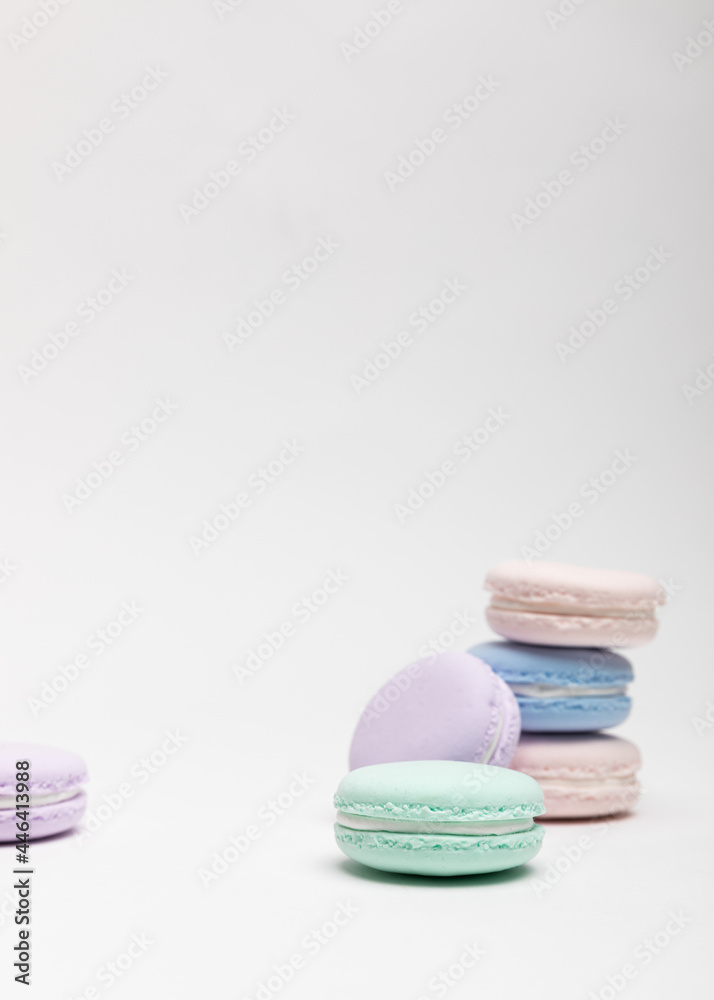 On a table with a white background, there are colorful model macaroons.
On a table with a white background, there are colorful model macaroons.