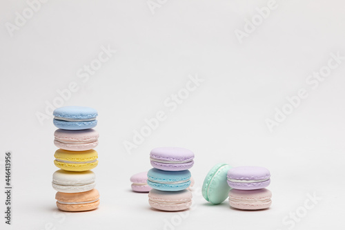 On a table with a white background, there are colorful model macaroons. 