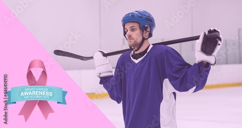 Composition of pink ribbon logo and breast cancer text, with hockey player