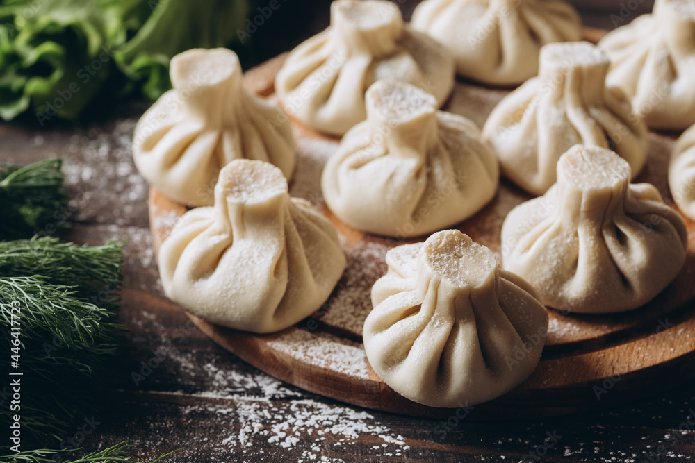 Fototapeta premium Georgian homemade dumpling or khinkali on cutting wooden board.