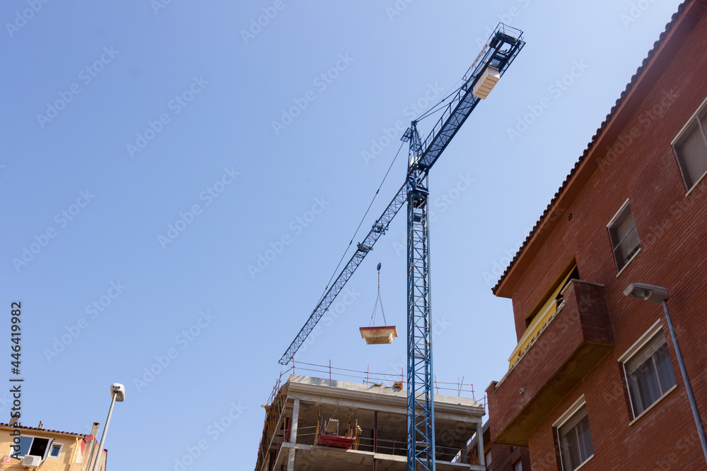 Crane working on a construction site Crane working on a construction site