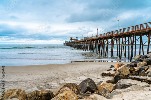 Amazing natural landscape with Oceanside Fishing Pier is located in California on a cloudy day. Ocean waves