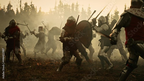 Epic Battlefield: Armies of Medieval Knights Fighting with Swords. Dark Ages Warfare. Action Battle of Armored Warrior Soldiers, Killing Enemies. Cinematic Historical Reenactment. Wide Slow Motion