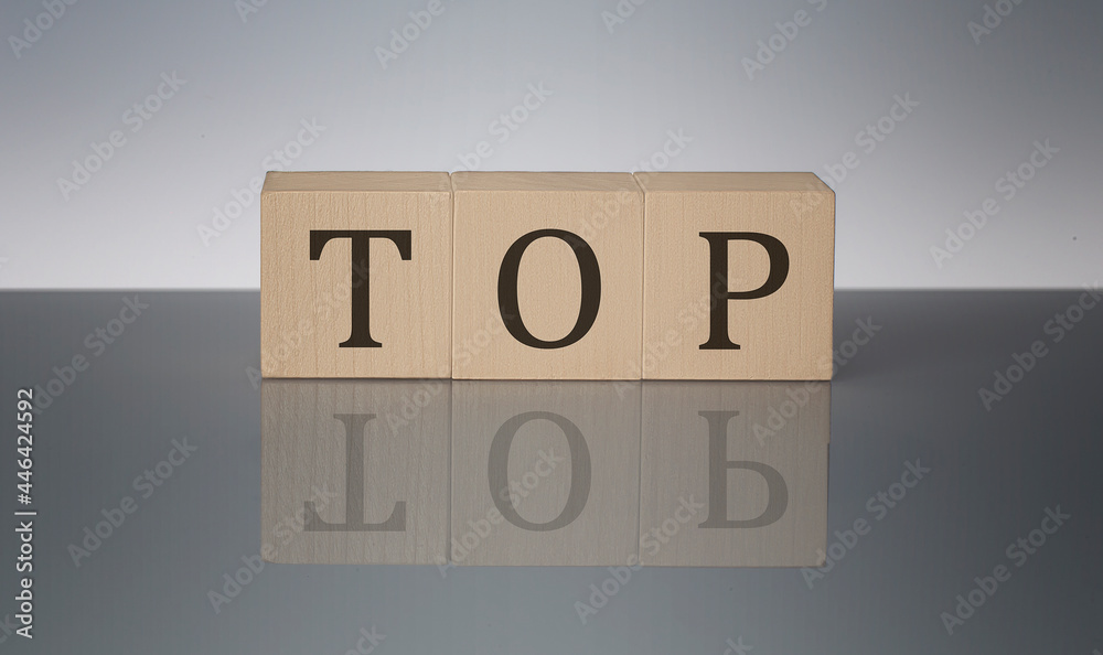 TOP concept, wooden word block on the grey background TOP concept, wooden word block on the grey background
