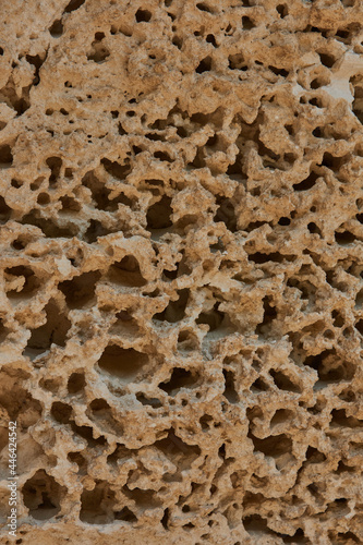 geological layers of yellow sand cliffs carved by wind and sea water texture