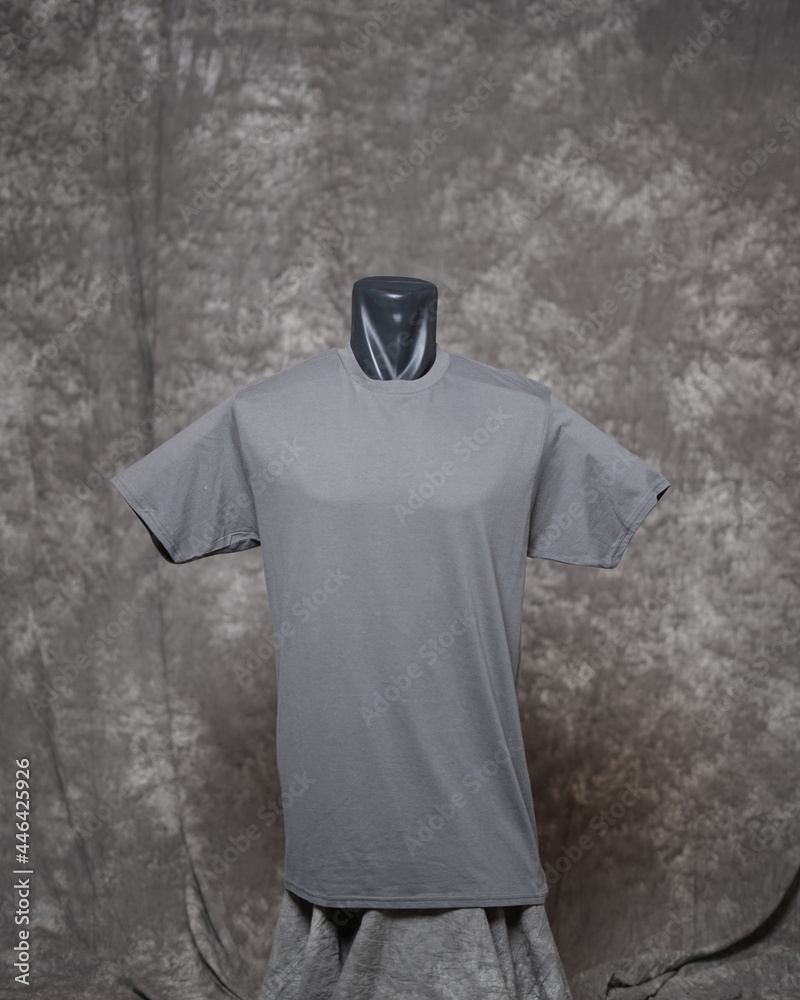 Gray men's blank t-shirt template, front side view, natural shape on invisible mannequin, for your design mockup for printing, isolated on gray motif background. Free space for your ad. Gray men's blank t-shirt template, front side view, natural shape on invisible mannequin, for your design mockup for printing, isolated on gray motif background. Free space for your ad.